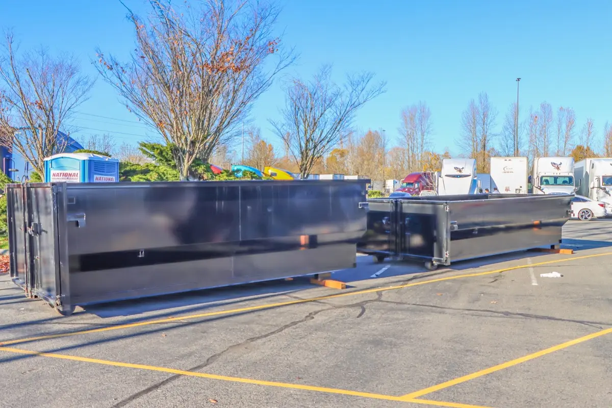 Professional dumpster rental service with roll-off container on residential driveway in San Leandro